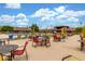 Resort style pool area with colorful seating, umbrellas, and beautifully landscaped surroundings at 111 S Greenfield Rd # 119, Mesa, AZ 85206
