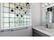 Bathroom featuring a granite sink, glass block window, and modern fixtures at 11342 E Laguna Azul Cir, Mesa, AZ 85209