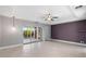 Bright bedroom featuring tile floors, a ceiling fan, and sliding glass doors at 11342 E Laguna Azul Cir, Mesa, AZ 85209