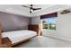 Bedroom with a ceiling fan, neutral walls, and a window view to the outside at 11342 E Laguna Azul Cir, Mesa, AZ 85209