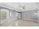 Spacious bedroom with tray ceiling, ceiling fan, and tile floors offers ample space at 11342 E Laguna Azul Cir, Mesa, AZ 85209