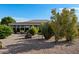 View of the rear exterior featuring low maintenance desert landscaping and enclosed sunroom at 11342 E Laguna Azul Cir, Mesa, AZ 85209