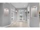 Bright foyer with tile flooring, recessed lighting, art niches, and a decorative glass front door at 11342 E Laguna Azul Cir, Mesa, AZ 85209