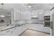 Well-lit kitchen featuring white cabinetry, granite countertops, and stainless steel appliances at 11342 E Laguna Azul Cir, Mesa, AZ 85209