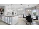 Modern kitchen featuring white cabinetry, granite countertops, an island, and a breakfast nook with stylish chairs at 11342 E Laguna Azul Cir, Mesa, AZ 85209