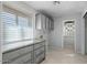 Laundry room featuring tile floors, granite countertops, and abundant cabinet space at 11342 E Laguna Azul Cir, Mesa, AZ 85209
