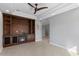 Living room with a built-in media center, fireplace, tile floors, and an archway to other living spaces at 11342 E Laguna Azul Cir, Mesa, AZ 85209