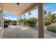 Enjoy the covered patio with brick pavers, decorative lighting, and serene desert landscaping at 11342 E Laguna Azul Cir, Mesa, AZ 85209