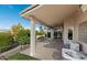 Rear covered patio with brick pavers, ceiling fans, and desert views overlooking a tranquil yard at 11342 E Laguna Azul Cir, Mesa, AZ 85209