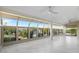 Spacious sunroom featuring tile floors, multiple ceiling fans and a wall of floor-to-ceiling windows at 11342 E Laguna Azul Cir, Mesa, AZ 85209