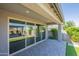 Covered back patio featuring pavers and retractable sliding glass doors at 11656 W Luxton Ln, Avondale, AZ 85323