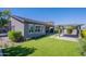 Well-maintained backyard with synthetic grass, covered patio, and seamless indoor/outdoor living at 11656 W Luxton Ln, Avondale, AZ 85323
