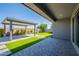 Artificial turf backyard and a gazebo extending from the back patio at 11656 W Luxton Ln, Avondale, AZ 85323