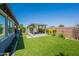 Backyard with pavers, low maintenance landscaping, and a gazebo at 11656 W Luxton Ln, Avondale, AZ 85323