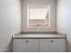 Bathroom features a window with a countertop and cabinet beneath at 11656 W Luxton Ln, Avondale, AZ 85323