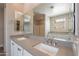 Bathroom features a double vanity with grey countertop and two sinks with chrome hardware at 11656 W Luxton Ln, Avondale, AZ 85323