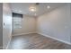 A well-lit bedroom featuring wood-look tile floors and a window with stylish valance at 11656 W Luxton Ln, Avondale, AZ 85323