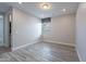 A well-lit bedroom features wood-look tile floors and a window with stylish valance at 11656 W Luxton Ln, Avondale, AZ 85323