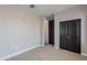 This vacant bedroom provides ample storage space, including large built-in closets and a calming neutral color palette at 11656 W Luxton Ln, Avondale, AZ 85323