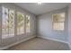 This vacant bedroom offers a versatile space with plenty of natural light and a calming neutral color palette at 11656 W Luxton Ln, Avondale, AZ 85323
