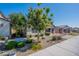 Beautiful single-story home featuring lush landscaping, a brick facade, and a view of neighboring properties at 11656 W Luxton Ln, Avondale, AZ 85323