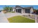 Stunning home featuring a three-car garage, a driveway with pavers, and easy-care desert landscaping at 11656 W Luxton Ln, Avondale, AZ 85323