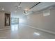 Open three car garage featuring epoxy floor and a clear glass garage door to the backyard at 11656 W Luxton Ln, Avondale, AZ 85323