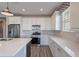 Well-equipped kitchen with stainless steel appliances, a large island, and sleek countertops for cooking and entertaining at 11656 W Luxton Ln, Avondale, AZ 85323