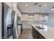 Modern kitchen showcasing stainless steel appliances, a central island, white cabinets, and stylish countertops at 11656 W Luxton Ln, Avondale, AZ 85323