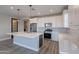 Beautiful kitchen featuring white cabinets, stainless steel appliances, light countertops, and wood-look tile flooring at 11656 W Luxton Ln, Avondale, AZ 85323