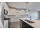 A kitchen featuring stainless steel appliances, a central island, and stylish finishes for a contemporary living experience at 11656 W Luxton Ln, Avondale, AZ 85323