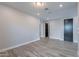 Open-concept living space with durable wood-look tile flooring and neutral color palette at 11656 W Luxton Ln, Avondale, AZ 85323