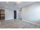Open-concept living space with durable wood-look tile flooring and neutral color palette at 11656 W Luxton Ln, Avondale, AZ 85323