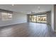 Spacious living room with wood-look tile floors and sliding glass doors to the backyard at 11656 W Luxton Ln, Avondale, AZ 85323