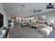 Open-concept living room with modern decor and wood-look flooring adjacent to kitchen at 11656 W Luxton Ln, Avondale, AZ 85323