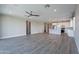 Open floor plan blending living room and modern white kitchen with island at 11656 W Luxton Ln, Avondale, AZ 85323