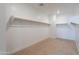 Spacious walk-in closet with carpet and shelving rods, ready for custom organization at 11656 W Luxton Ln, Avondale, AZ 85323