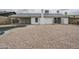 Gravel backyard featuring a pool, patio, and white painted house at 12228 S Pewaukee St, Phoenix, AZ 85044