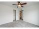 Bedroom boasts a ceiling fan and closet with storage space and gray carpeting at 12228 S Pewaukee St, Phoenix, AZ 85044