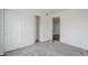 This bedroom features a closet, an entry door, and gray carpeting at 12228 S Pewaukee St, Phoenix, AZ 85044