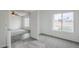 Sunlit bedroom featuring gray carpeting and neutral walls adjacent to tile at 12228 S Pewaukee St, Phoenix, AZ 85044