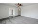 Spacious room featuring a ceiling fan, grey carpet, and a large window with great light at 12228 S Pewaukee St, Phoenix, AZ 85044