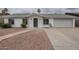 Charming single-story home with a well-maintained front yard and an attached two-car garage at 12228 S Pewaukee St, Phoenix, AZ 85044