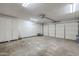 Spacious garage with ample storage cabinets and an automatic garage door at 12228 S Pewaukee St, Phoenix, AZ 85044
