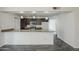 The open kitchen features granite countertops, stainless steel appliances, and a breakfast bar at 12228 S Pewaukee St, Phoenix, AZ 85044