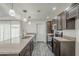 Stylish kitchen featuring stainless steel appliances, stone counters, and access to the living area at 12228 S Pewaukee St, Phoenix, AZ 85044