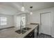 Bright kitchen featuring stainless steel appliances, a stone countertop, and views to living spaces at 12228 S Pewaukee St, Phoenix, AZ 85044