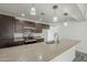 Kitchen featuring stone countertops, stainless steel appliances, and dark cabinetry for modern charm at 12228 S Pewaukee St, Phoenix, AZ 85044
