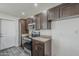 Kitchen features stainless steel appliances, granite countertops, and dark wood cabinetry at 12228 S Pewaukee St, Phoenix, AZ 85044
