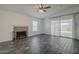 Inviting living room with a decorative fireplace, neutral décor, and sliding doors to the backyard at 12228 S Pewaukee St, Phoenix, AZ 85044